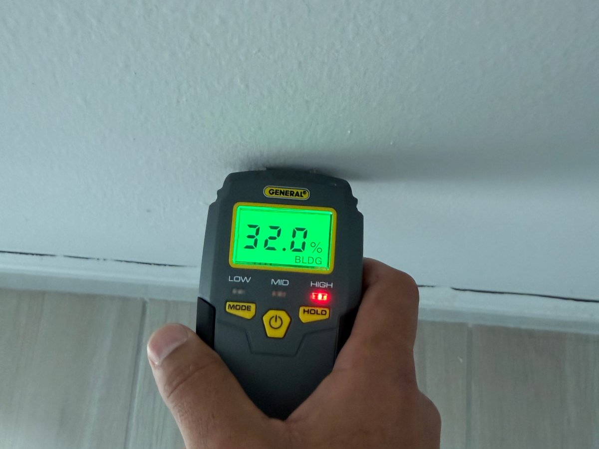 Moisture meter taking a reading on an interior wall during a property inspection