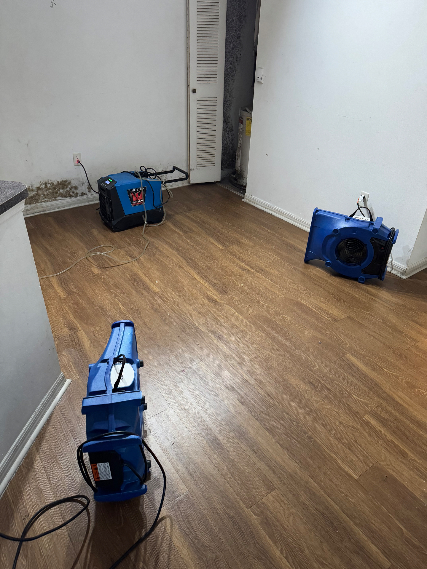 Industrial dehumidifier and air movers deployed for structural drying in a Tamarac apartment