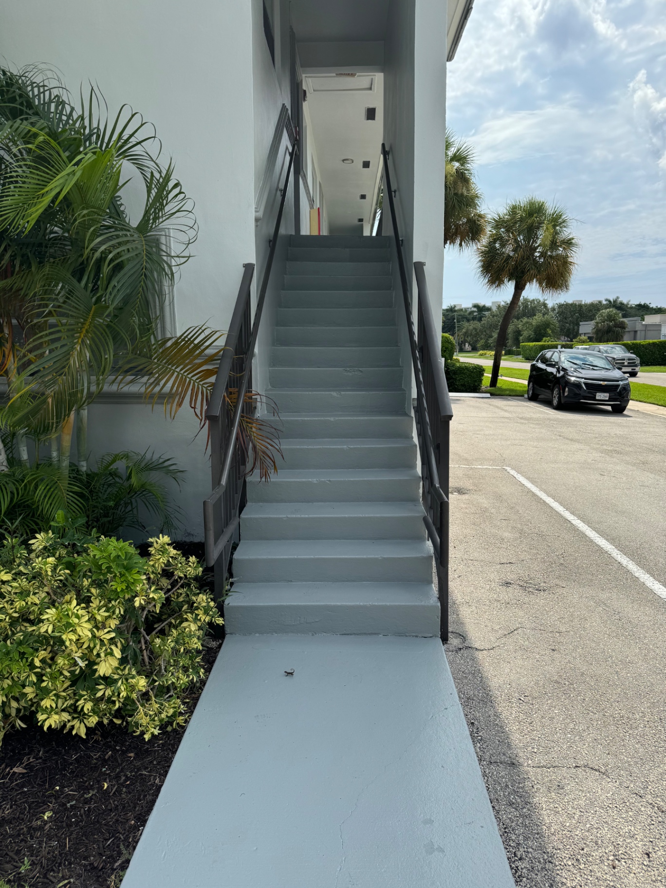 Repainted stairwell with non-slip touch-ups at a Pompano Beach multifamily community